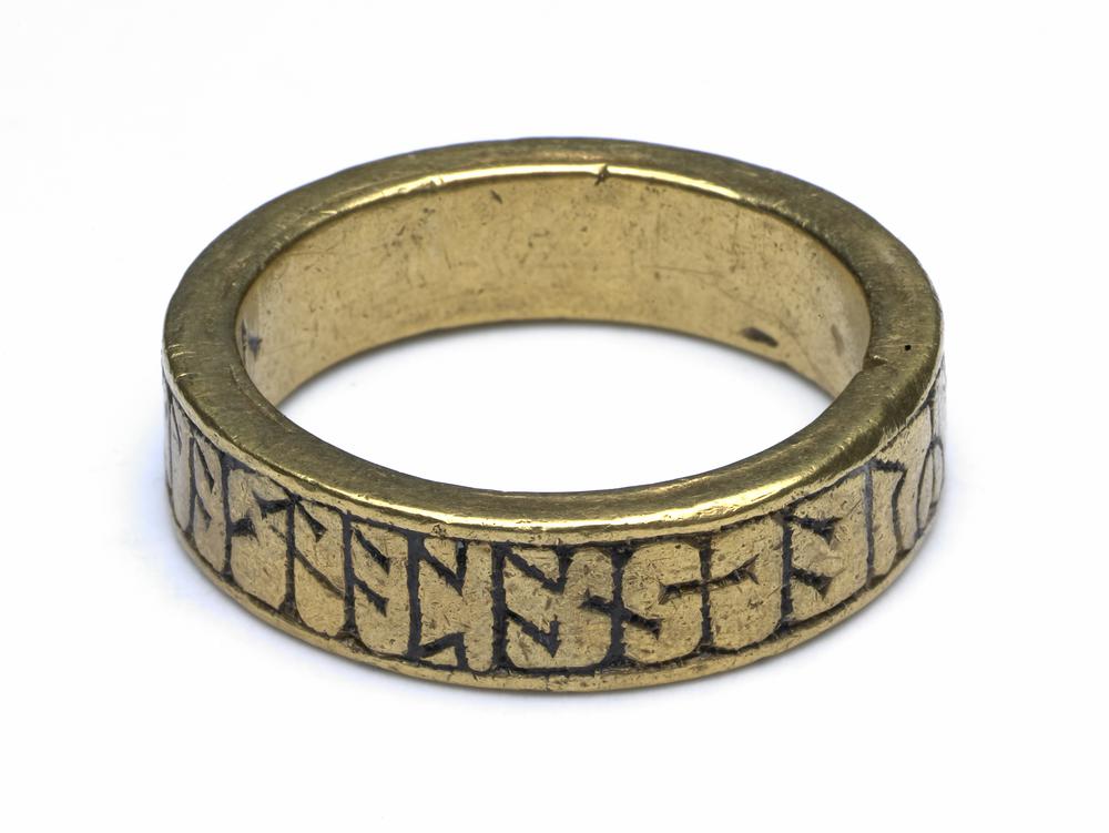 Gold ring, with runes inscribed around the outside.