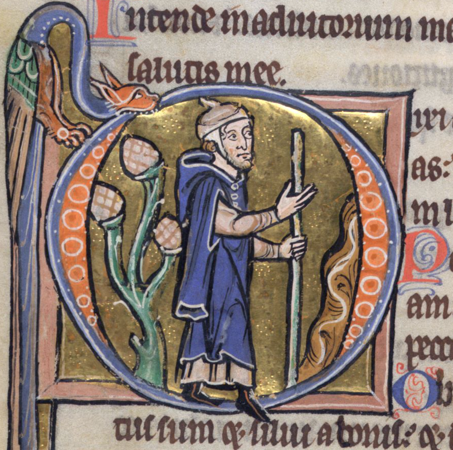 Medieval historiated initial decorated with a winged dragon, containing a pilgrim with a staff.