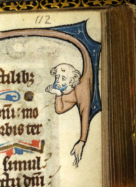 Medieval manuscript image of bald man’s head and arms extending down from part of a large initial, his right hand raised to his chin and his left hanging below him.