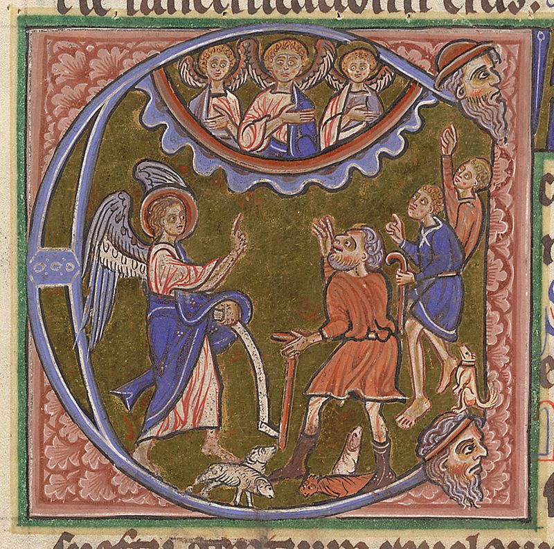 Medieval illuminated initial C containing an angel speaking to three shepherds while three other angels watch from a cloud above them; the shepherds have unusually small sheep around their feet and a very small dog.