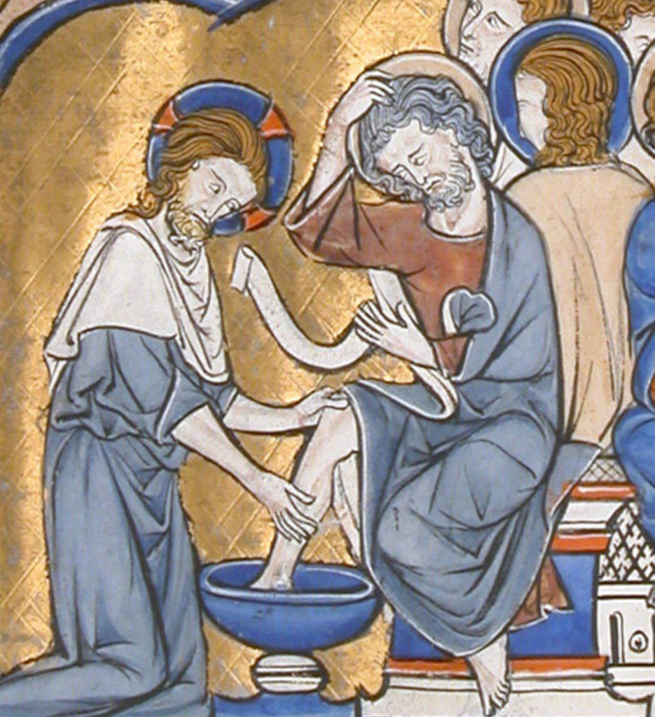Medieval manuscript image of a nimbed Christ bent on his knees to wash the feet of a nimbed, grey-haired man, whose robe is pulled up to his knee and who sits on a bench with other nimbed men.