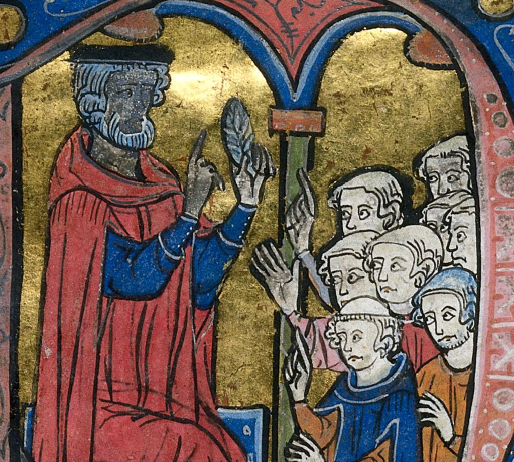 Medieval manuscript image of a teacher lecturing to a group of students who sit at his feet.