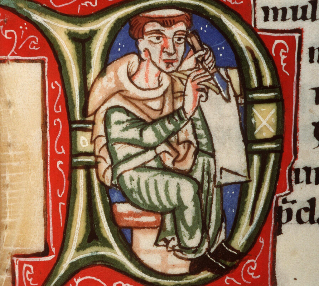 Inside an initial D in a medieval manuscript, a monk writes on a piece of parchment.