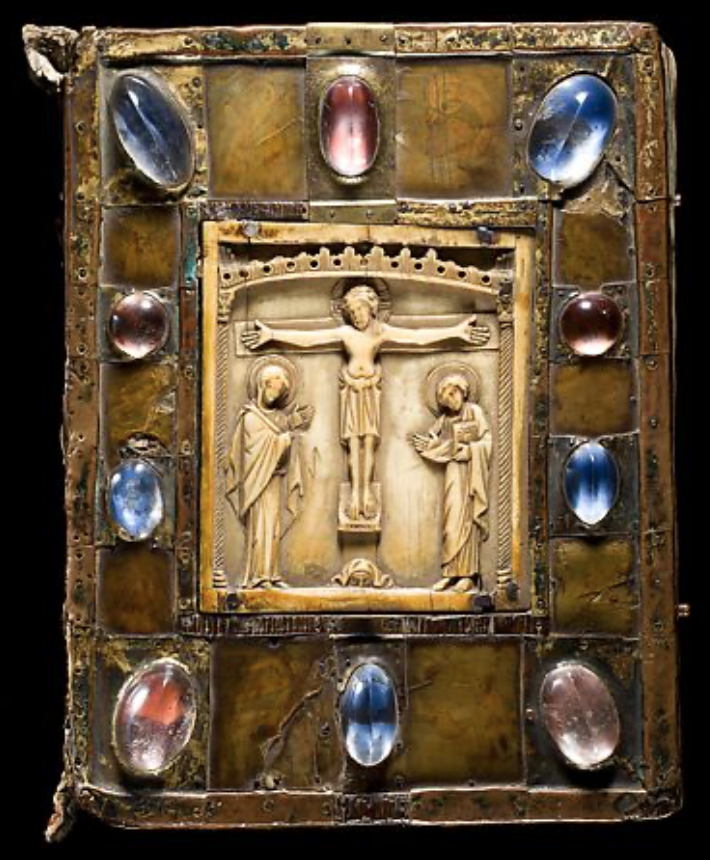 Medieval book cover with an ivory in the centre depicting the crucifixion, decorated around the frame with polished blue and red rock crystals.