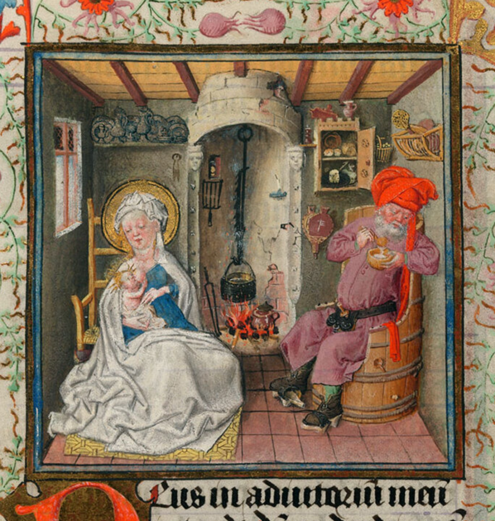Medieval manuscript illustration of a haloed woman nursing her child and a bearded man sitting in a barrel chair and eating from a bowl inside a house; in the background is a cooking pot hanging above a fire, a storage cabinet, a shelf  with pewter plates, a utensil rack, and a small window.
