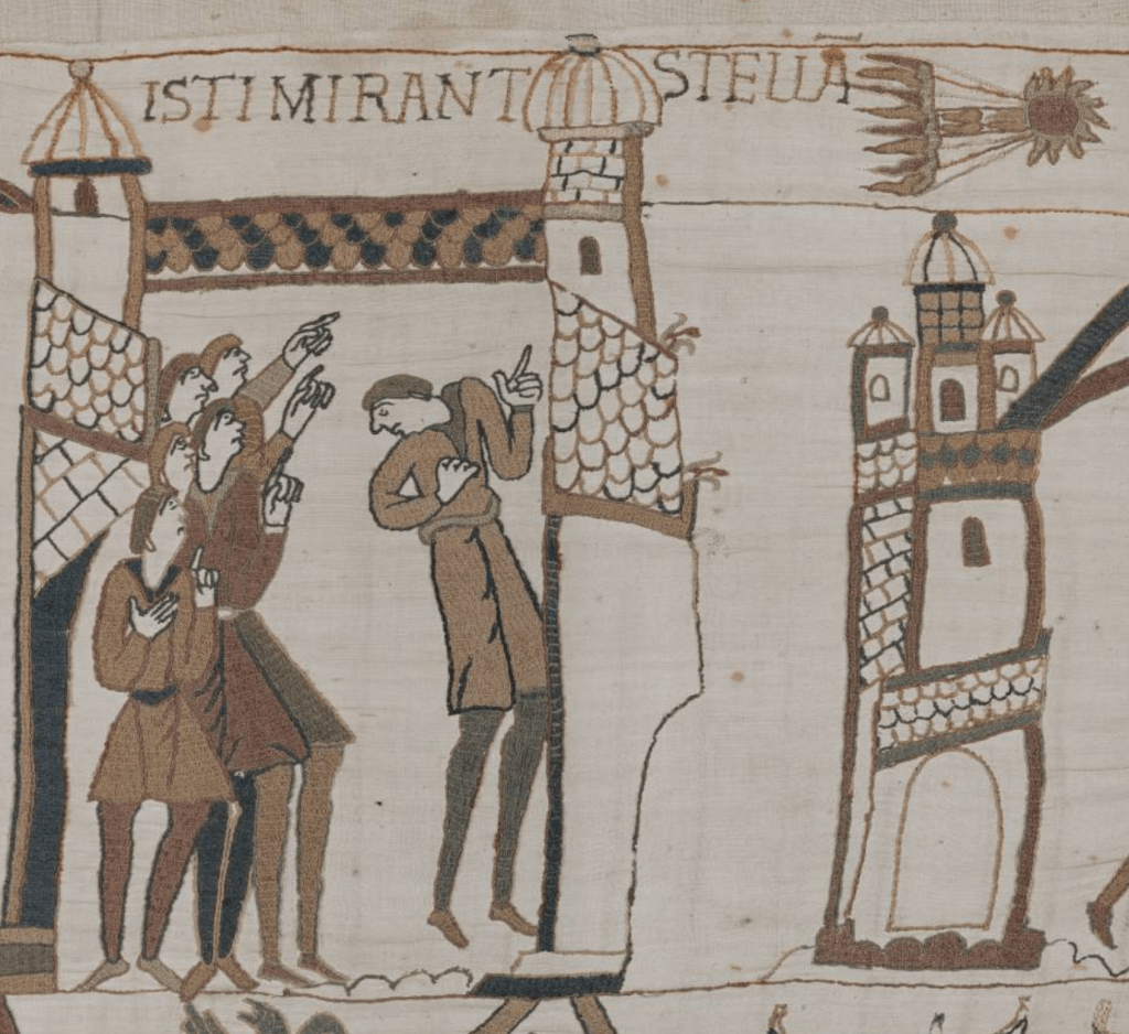 Medieval tapestry depicting a group of men pointing up at a comet soaring brightly across the sky, with the Latin caption ‘Isti mirant stella’.